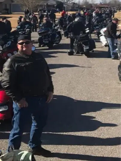 A man standing in front of a group of motorcycles.